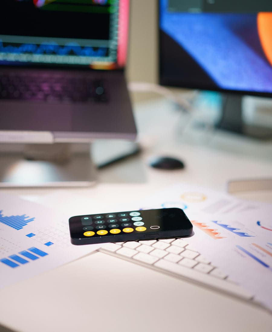 Financial charts and a calculator on a working desk