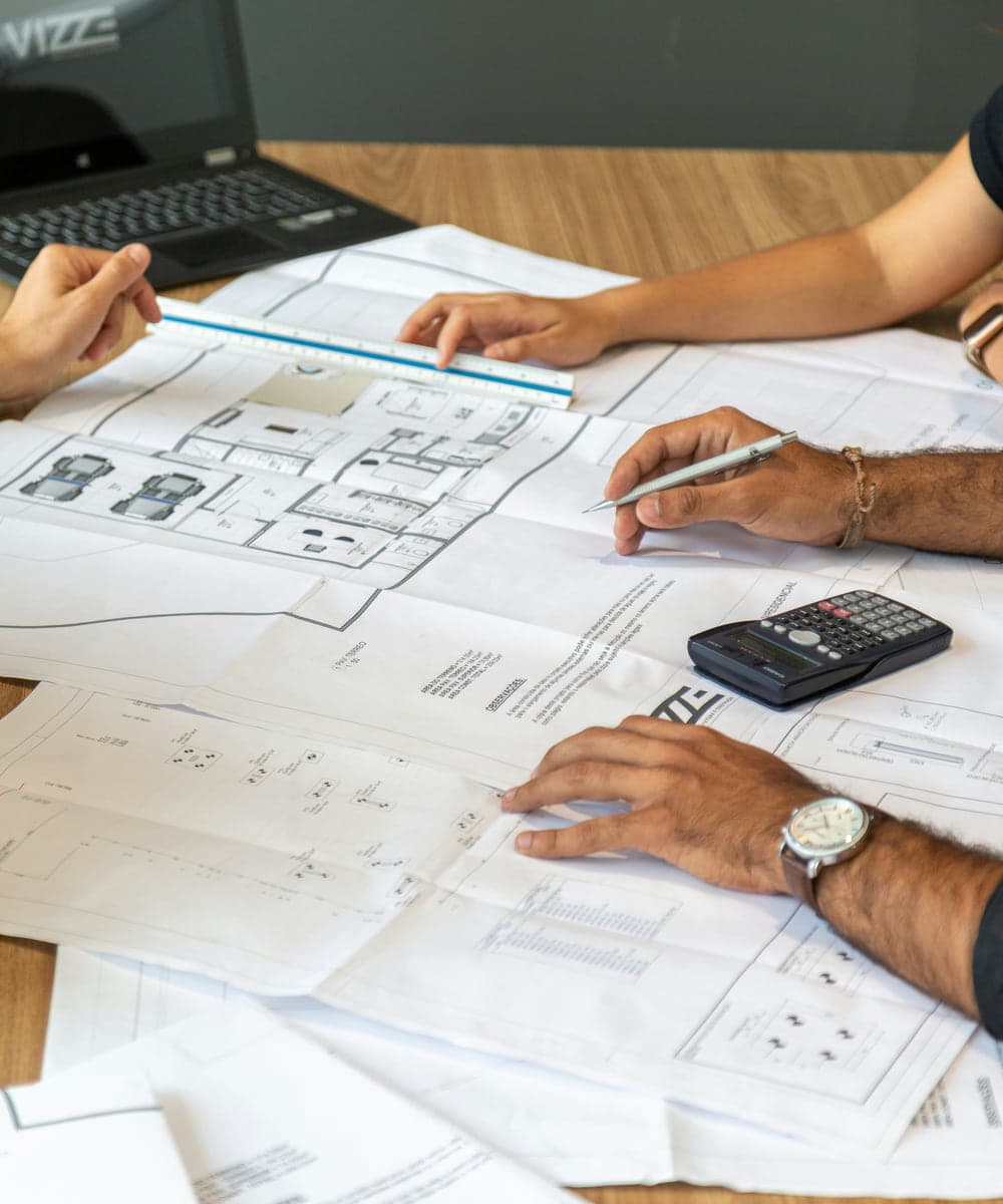 Reviewing plans and figures across a desk